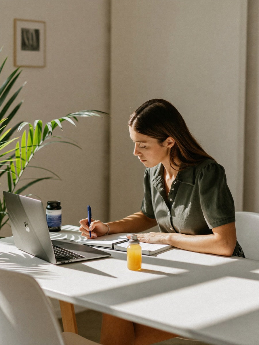 Woman working with calm focus at a bright desk